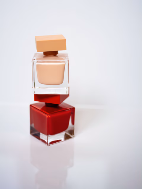 Two perfume bottles on a minimal studio set